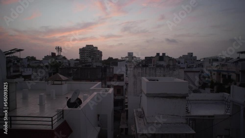 View from Indian House Hold top floor Balcony, Surat, India during Sunset birds flying in distance photo