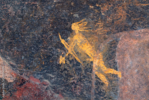 Bushmen rock painting of a human figure with a hunting bow and arrow, South Africa. photo