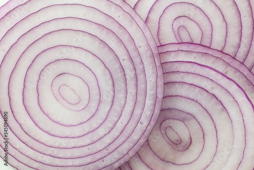 Sliced red onions, arranged. Full frame of crosswise thin sliced red onion cross sections.