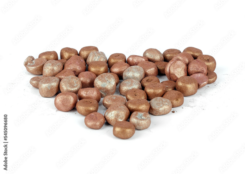 Balls of bronzing face powder shaped like a heart, bronzing pearls isolated on white background Balls of bronzing face powder shaped like a heart, bronzing pearls isolated on white background
