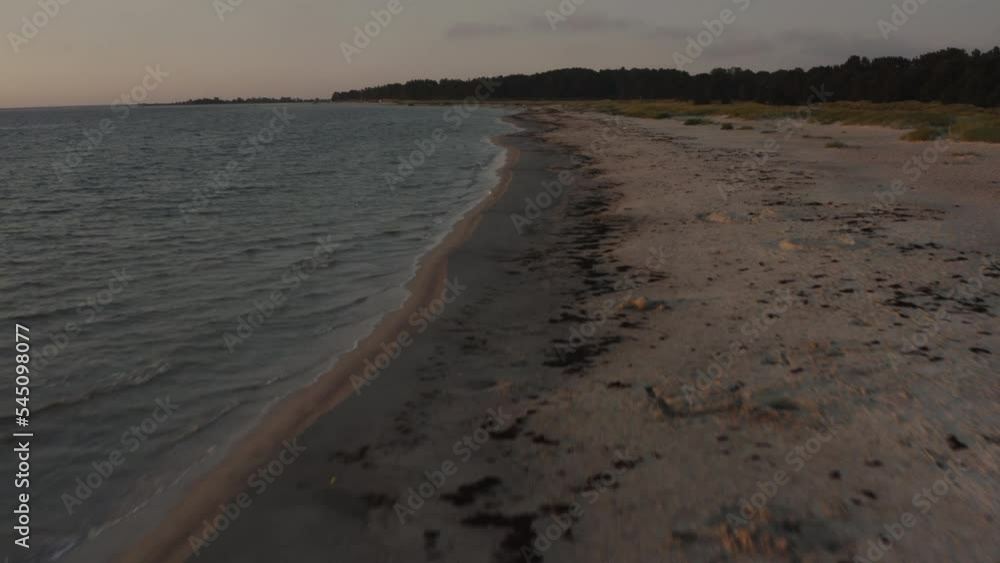 4k Drone flying close to the sand beach and ocean water during sunet. 4k Drone flying close to the sand beach and ocean water during sunet.
