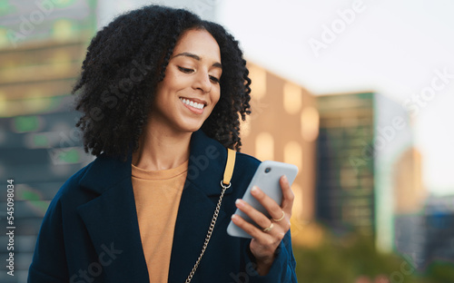 Fototapeta Business woman, phone and typing in city, street or outdoors on social media, text message or web browsing