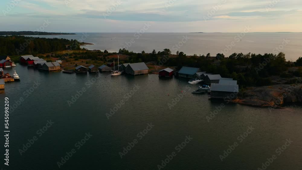 Aerial view of Boat sheds at the Karingsund marina, gloomy, summer evening in Eckero, Aland, Finland - tracking, drone shot Aerial view of Boat sheds at the Karingsund marina, gloomy, summer evening in Eckero, Aland, Finland - tracking, drone shot