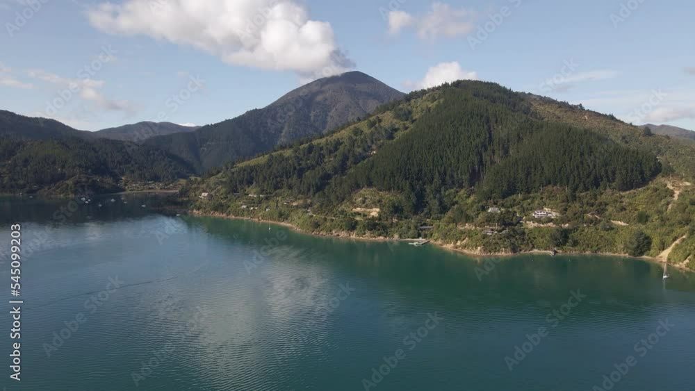 Big cumulus clouds touching the peaks of abundant, coastal mountains in Marlborough, New Zealand Big cumulus clouds touching the peaks of abundant, coastal mountains in Marlborough, New Zealand
