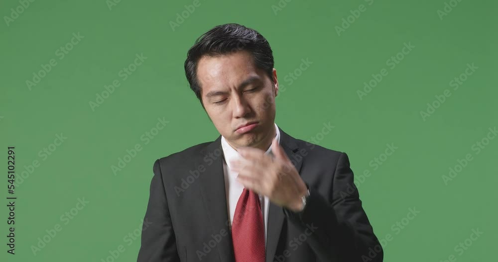 Tired Asian Business Man While Standing In Front Of Green Screen
Tired Asian Business Man While Standing In Front Of Green Screen