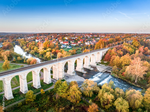 Fototapeta Naklejka Na Ścianę i Meble -  A unique autumn aerial shot of a rail bridge (wiadukt kolejowy) in Boleslawiec, Poland