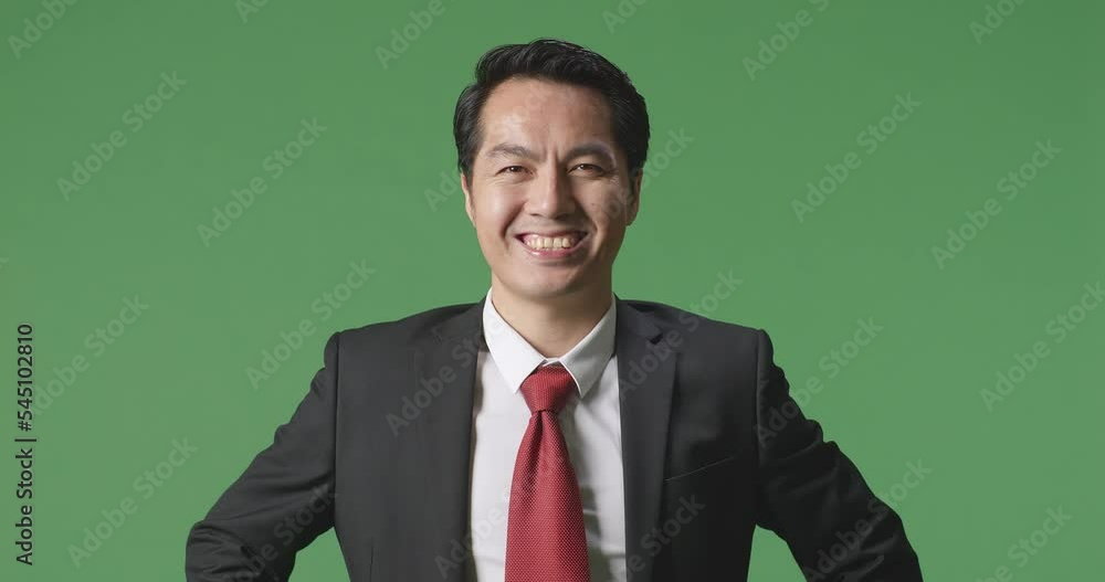 An Asian Business Man Warmly Smiling On Green Screen Background In The Studio
An Asian Business Man Warmly Smiling On Green Screen Background In The Studio