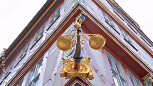 Golden justice statue on a building in Frankfurt, Germany photo