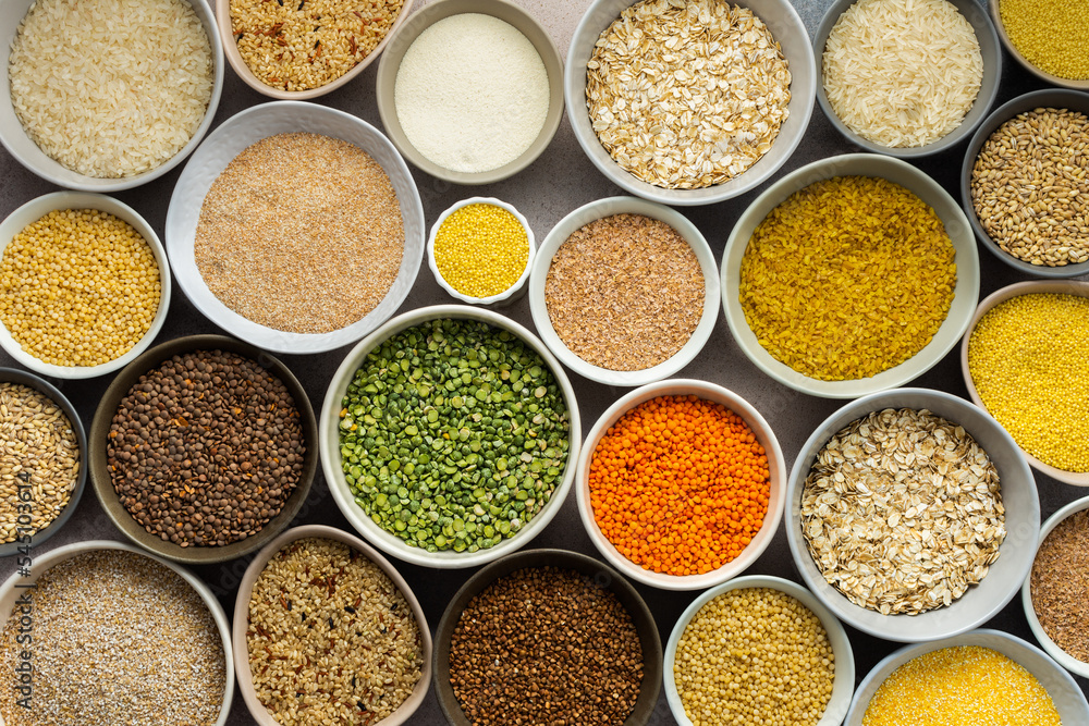 Various grain cereals in bowls on a light background, top view Various grain cereals in bowls on a light background, top view