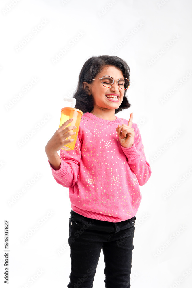 Indian happy little girl drinking juice Indian happy little girl drinking juice