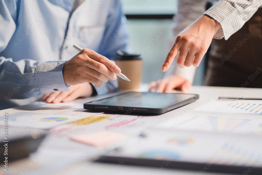 Group of business people meeting together Pointing to the graph assess business profits. Group of business people meeting together Pointing to the graph assess business profits.
