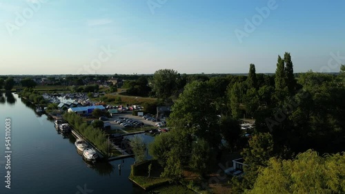 Waterfront Structures, Parking Lot, And Moored Boat In The Town Of Arkel, Netherlands. aerial photo