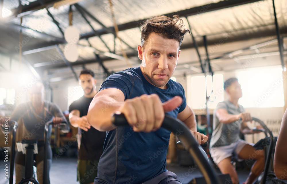 Bike, class and exercise man portrait with cycling training, wellness and fitness gym group. Athlete with motivation doing a bicycle, sports and spinning workout at a health cub or studio with people Bike, class and exercise man portrait with cycling training, wellness and fitness gym group. Athlete with motivation doing a bicycle, sports and spinning workout at a health cub or studio with people