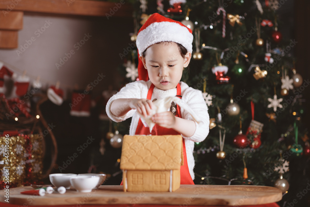 young girl making gingerbread house at home young girl making gingerbread house at home