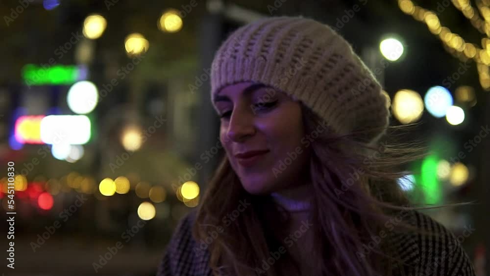 Happy woman smile and dance at night with a defocused background of city lights in Amsterdam Happy woman smile and dance at night with a defocused background of city lights in Amsterdam