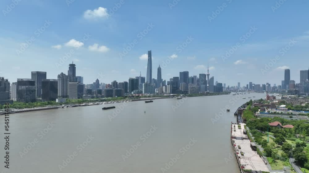 The Huangpu river and city skyline of Shanghai . Drone aerial view. Clear sky and blue river in sunny day during hour in Shanghai China. Cityscape, business, economy concept b-roll footage. The Huangpu river and city skyline of Shanghai . Drone aerial view. Clear sky and blue river in sunny day during hour in Shanghai China. Cityscape, business, economy concept b-roll footage.