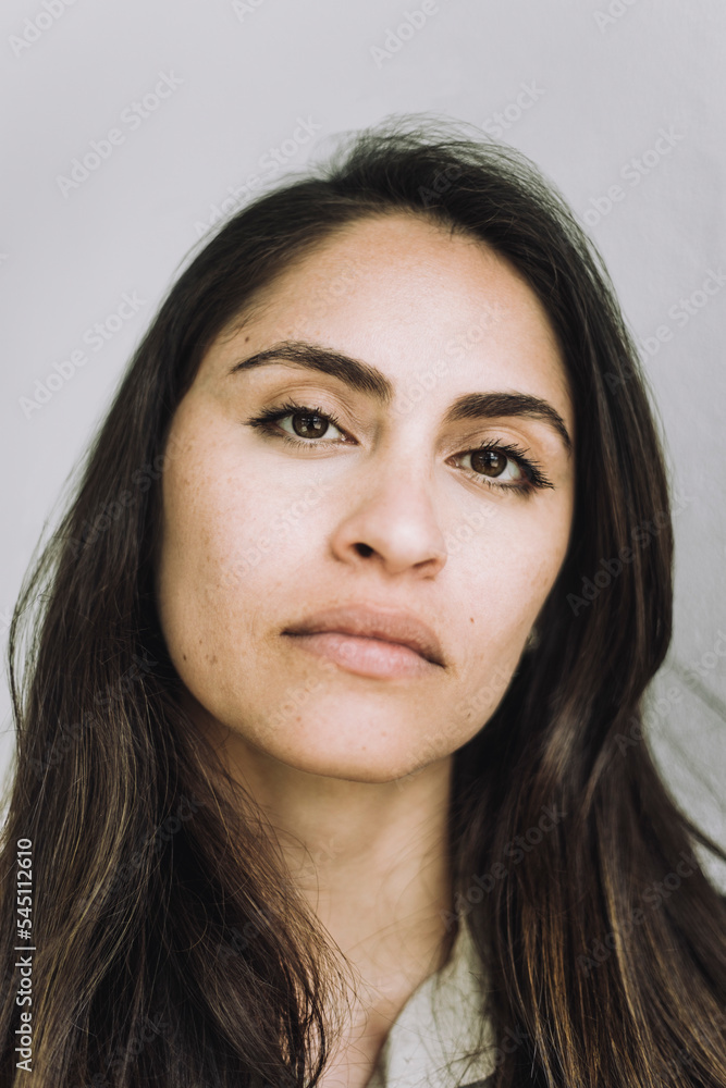 Portrait of confident female design professional against gray background Portrait of confident female design professional against gray background