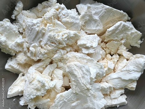 Fresh cottage cheese in an aluminum bowl. Close-up.