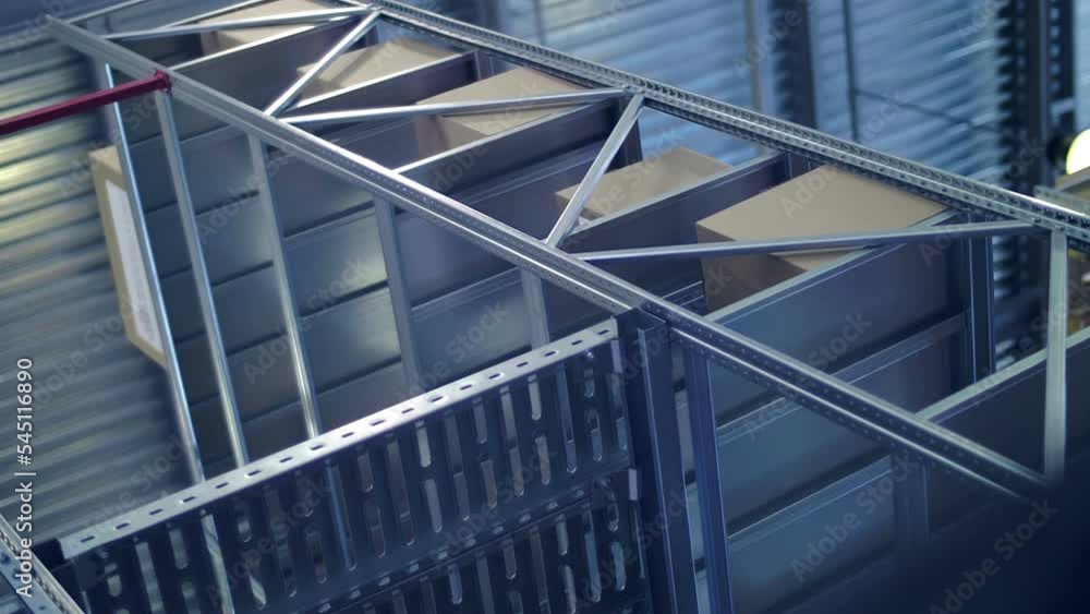 Metal racks with cardboard boxes in a large warehouse Metal racks with cardboard boxes in a large warehouse
