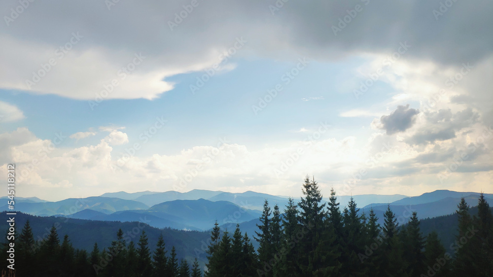 clouds over the mountains before sunset, blue cloudy sky
