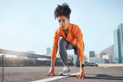 Runner, black woman and street for race, start or sprint in exercise, workout and training in city. Woman, focus and running for fitness, sport and health on road, metro or urban town in sunshine