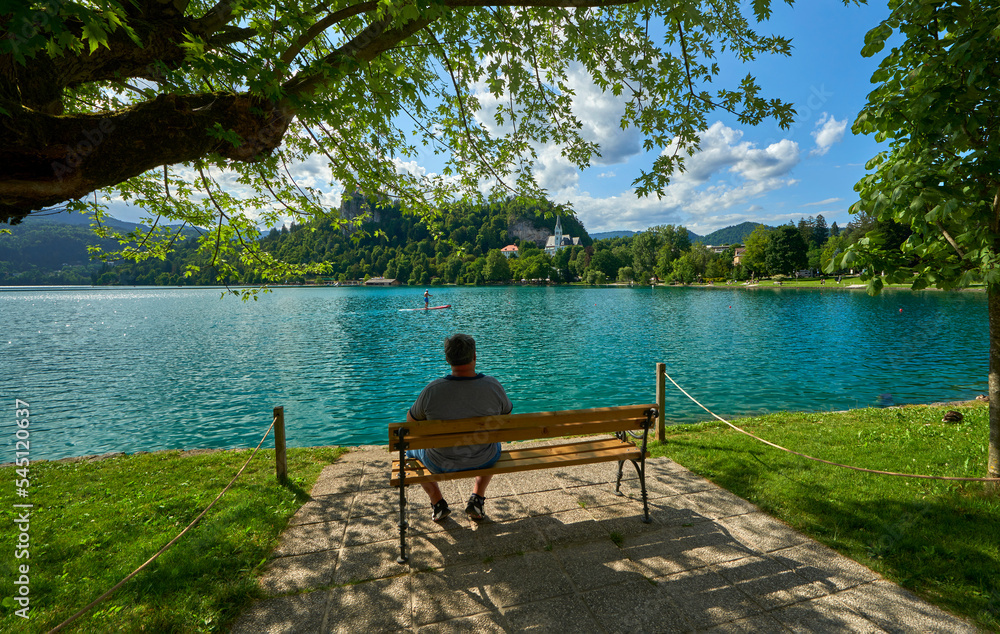 Man on the bench at Bled lake promenade, Slovenia Man on the bench at Bled lake promenade, Slovenia