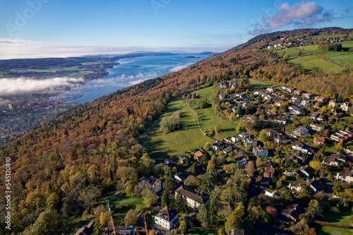 Aerial view from village Evilard, Canton Bern, over Biel Bienne Lake on a clue cloudy autumn day. Photo taken November 10th, 2022, Evilard, Switzerland.