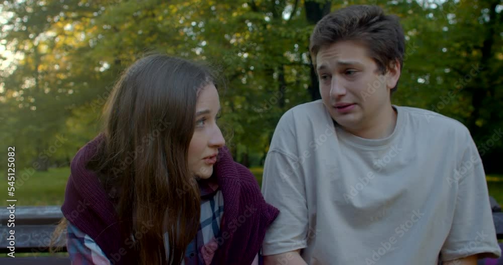 Portrait of communicating young people. Guy talking to girl, lifestyle outdoor. Relationship crisis, couples face complex challenges that threaten to tear their union apart. Effective communication. Portrait of communicating young people. Guy talking to girl, lifestyle outdoor. Relationship crisis, couples face complex challenges that threaten to tear their union apart. Effective communication.
