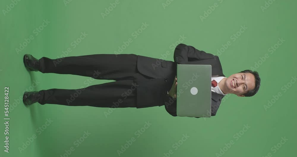Full Body Of Asian Business Man Using Laptop Computer And Smiling To Camera On Green Screen Background In The Studio
Full Body Of Asian Business Man Using Laptop Computer And Smiling To Camera On Green Screen Background In The Studio