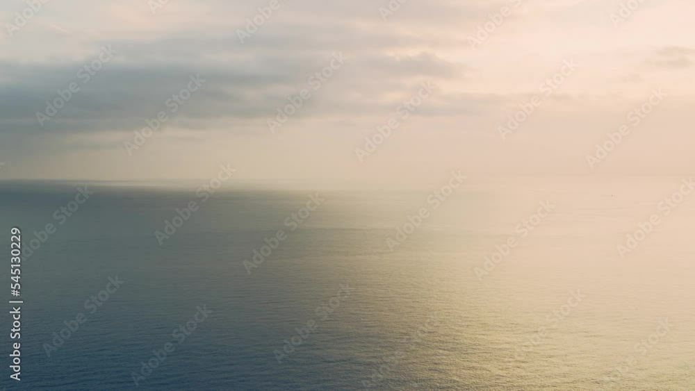 Aerial Drone View of Calming Peaceful Orange Ocean Seascape Background of Vast Sea and Sunset Clouds over Horizon with Copy Space, Calm Still Water Aerial Drone View of Calming Peaceful Orange Ocean Seascape Background of Vast Sea and Sunset Clouds over Horizon with Copy Space, Calm Still Water