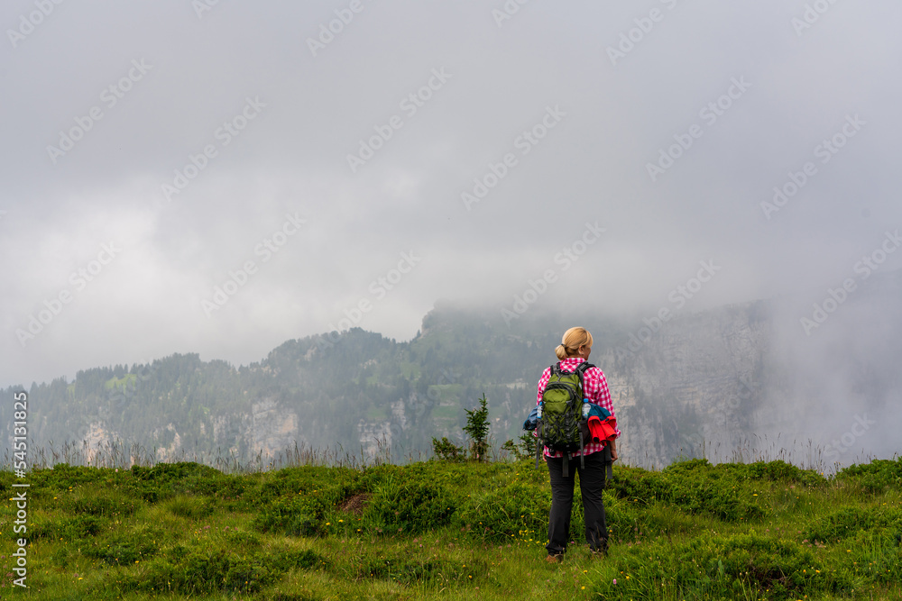 Backpacker hiking in the mountains in Switzerland.