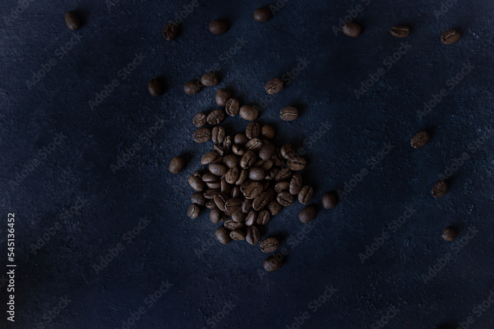Coffee beans on a dark background, roasted coffee beans, or seeds Coffee beans on a dark background, roasted coffee beans, or seeds