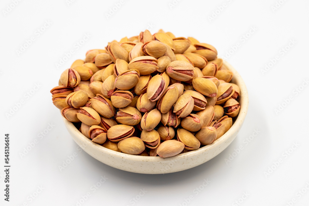 Pistachio. Pistachios in bowl on white background. close up Pistachio. Pistachios in bowl on white background. close up