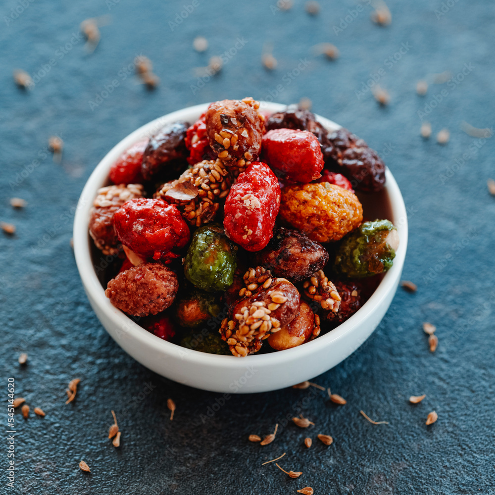 bowl with an assortment of candied peanuts bowl with an assortment of candied peanuts