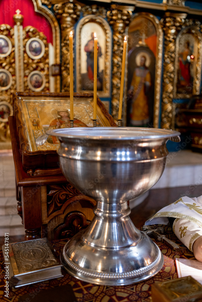 metal font for christening in the church with candles metal font for christening in the church with candles