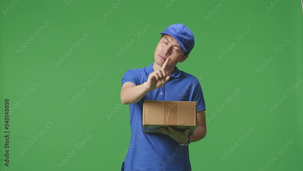 Asian Male Courier In Blue Uniform Showing No Gesture While Delivering A Carton On Green Screen Background In The Studio
Asian Male Courier In Blue Uniform Showing No Gesture While Delivering A Carton On Green Screen Background In The Studio