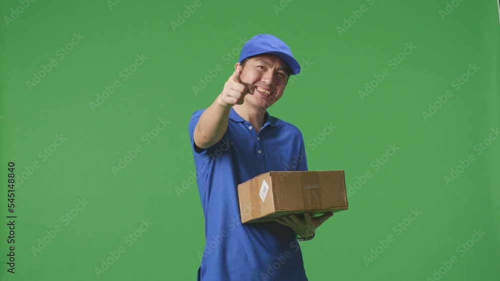 Asian Male Courier In Blue Uniform Smiling And Making Honest Gesture While Delivering A Carton On Green Screen Background In The Studio
Asian Male Courier In Blue Uniform Smiling And Making Honest Gesture While Delivering A Carton On Green Screen Background In The Studio
