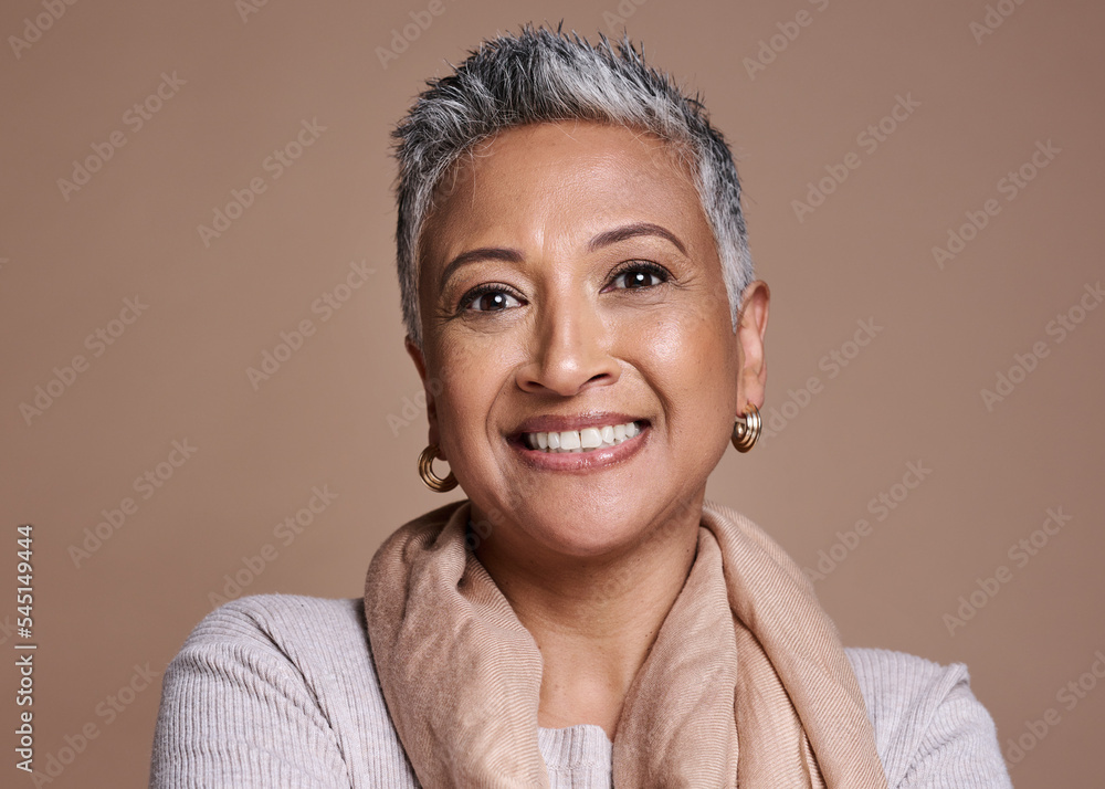 Foto Stock Face, fashion and senior woman in studio isolated against a  brown background. Beauty portrait, smile and makeup cosmetics or aesthetics  of happy elderly model from India in designer scarf or