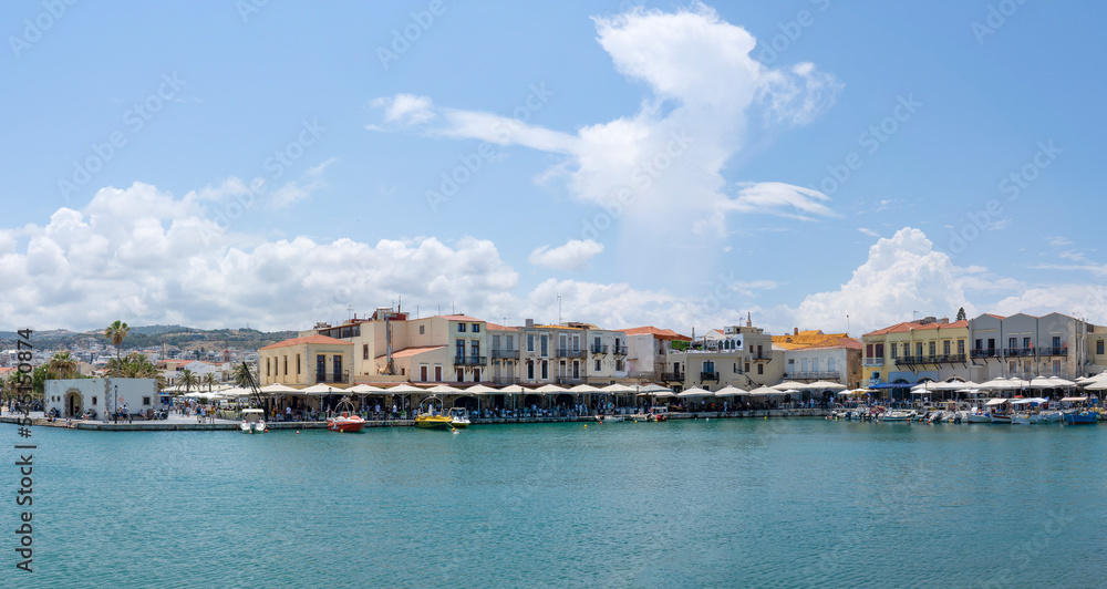 Panoramic photo of the Venetian harbor with on the far left the Old Customs House, the colorful buildings and the many restaurants in Rethymno, Crete, Greece