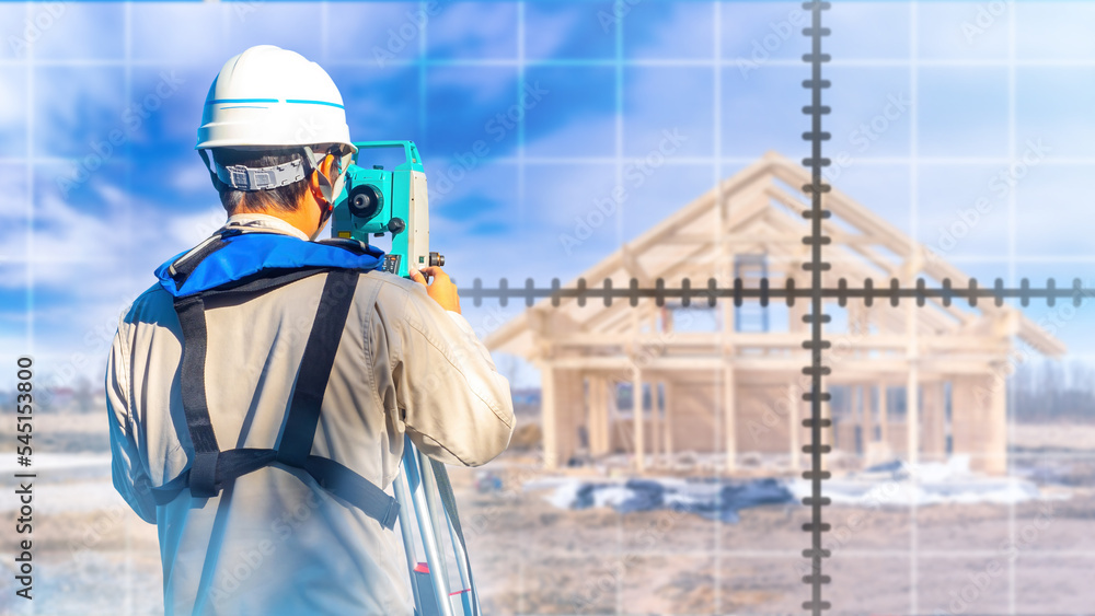 Man surveyor. Guy surveying instrument with his back to camera. Surveyor examines construction
