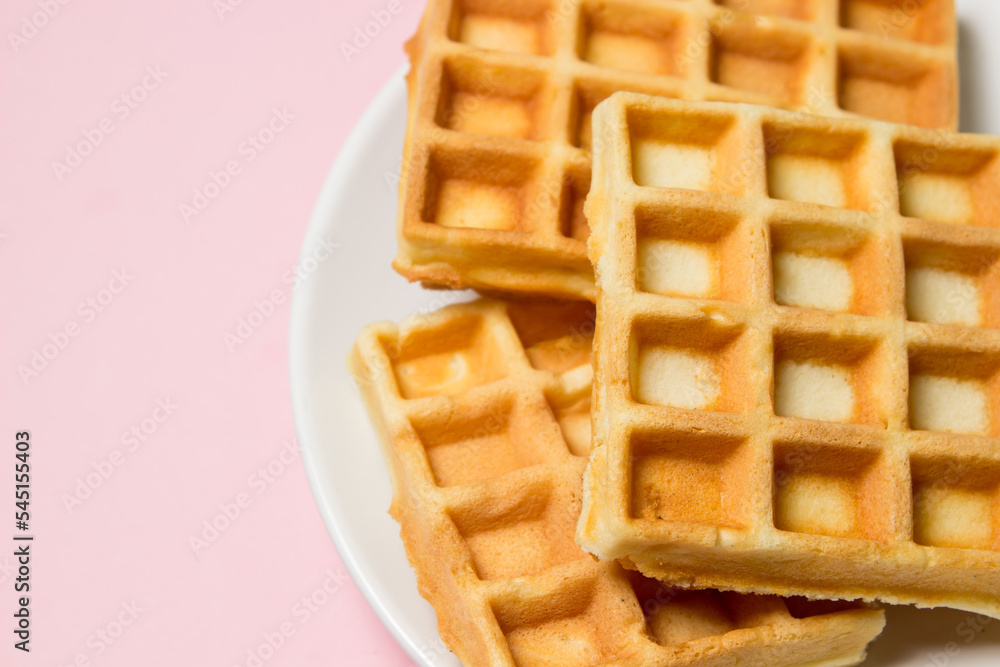 Homemade waffles on a pink background. Tasty breakfast Homemade waffles on a pink background. Tasty breakfast