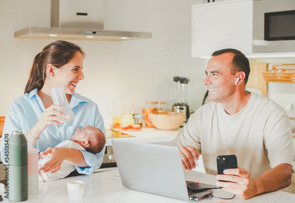 Happy family with baby and working in kitchen Happy family with baby and working in kitchen