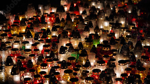 Bild auf Leinwand Lot of burning candles at night in cemetery