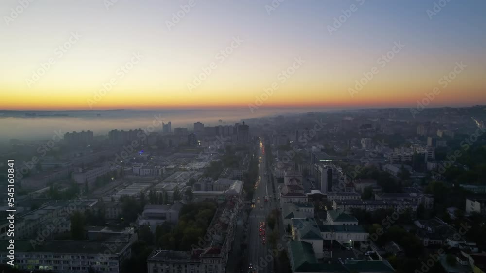 Aerial drone view of Chisinau at sunrise, Moldova. View of city centre covered with fog, multiple buildings Aerial drone view of Chisinau at sunrise, Moldova. View of city centre covered with fog, multiple buildings