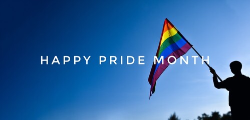 'HAPPY PRiDE MONTH' on bluesky and rainbow flags background, concept for lgbtq+ celebrations in pride month, june, 2023.	