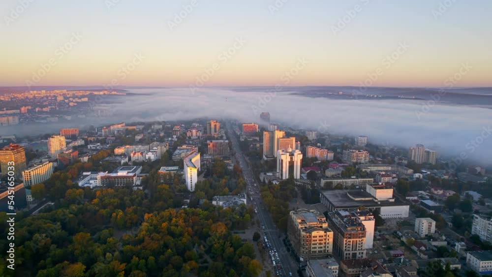 Aerial drone view of Chisinau at sunrise, Moldova. View of city centre covered with fog, multiple buildings, presidency and parliament Aerial drone view of Chisinau at sunrise, Moldova. View of city centre covered with fog, multiple buildings, presidency and parliament