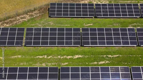 Aerial view, massive Solar panel farm on the field, alternative energy