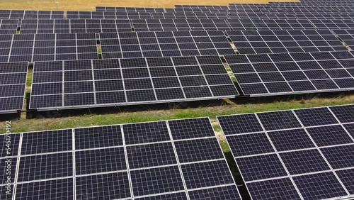 Aerial view, massive Solar panel farm on the field, alternative energy