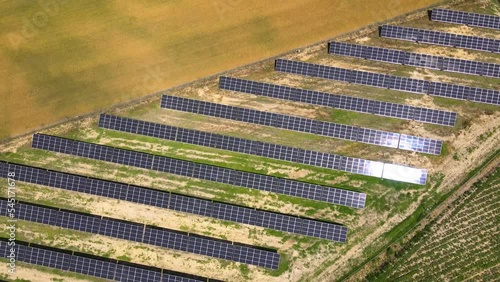 Aerial view, massive Solar panel farm on the field, alternative energy