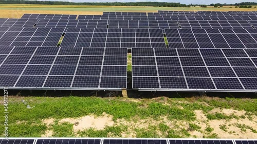 Aerial view, massive Solar panel farm on the field, alternative energy